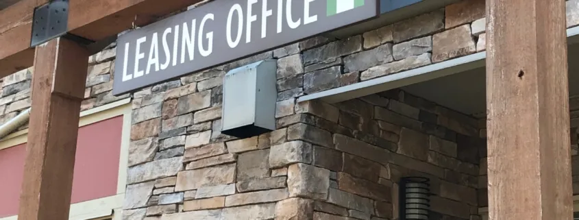 Leasing office sign on stone building